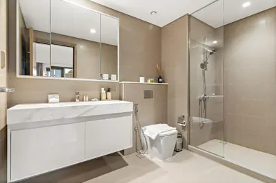 a bathroom with a sink and a shower and a toilet at FIRST CLASS 2BR Burj Khalifa & Pool Views in Dubai