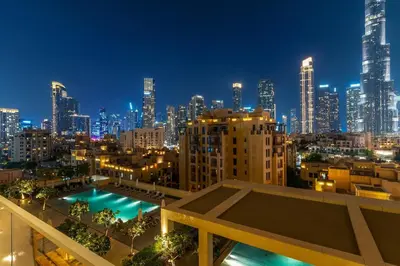 a view of a city skyline at night at FIRST CLASS 2BR Burj Khalifa & Pool Views in Dubai