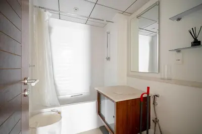 a bathroom with a sink and a tub and a window at Exquisite 2BR Apartment in Dubai Marina in Dubai