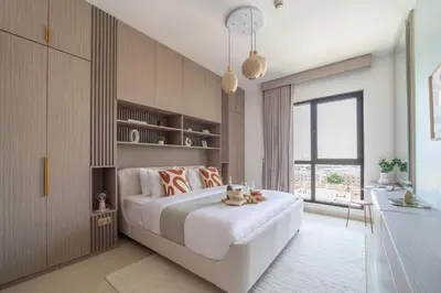 a bedroom with a large white bed and a window at Frank Porter - Rahaal 2 in Dubai
