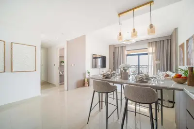 a kitchen with a counter and stools in a room at Frank Porter - Rahaal 2 in Dubai