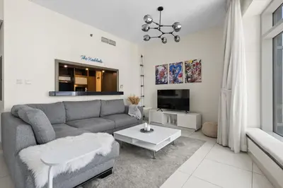 a living room with a couch and a table at Stunning 2BR in Downtown Partial Burj Khalifa View in Dubai