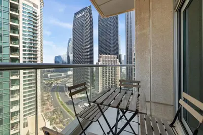 a balcony with a bench and a view of the city at Stunning 2BR in Downtown Partial Burj Khalifa View in Dubai