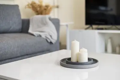 a living room with a couch and two candles on a table at Stunning 2BR in Downtown Partial Burj Khalifa View in Dubai