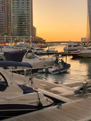 a group of boats docked in a marina at sunset at 2bed Canalside Home - Marina in Dubai