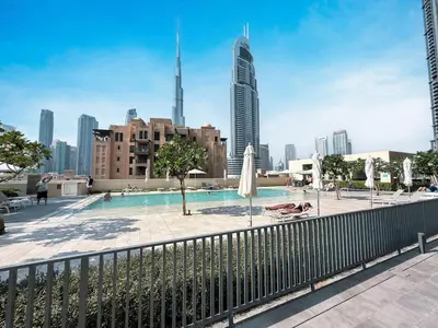 a swimming pool with a city skyline in the background at New LUX 1 BDR apartment in Downtown Dubai in Dubai