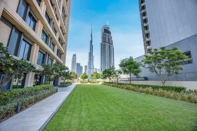 a lawn in the middle of a city with buildings at New LUX 1 BDR apartment in Downtown Dubai in Dubai