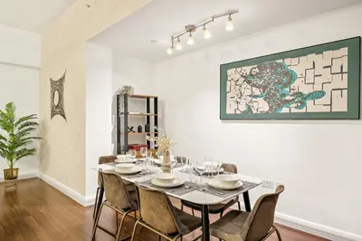 a dining room with a table and chairs at FIRST CLASS 2BR Vibrant Retreat Near JBR Beach in Dubai