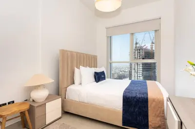 a bedroom with a large bed and a window at CitiHome - Modern Stay - Dubai Hills 2BR in Dubai