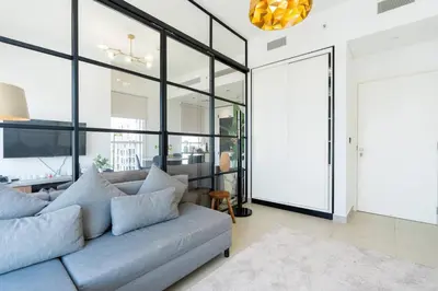 a living room with a couch and large windows at CitiHome - Modern Stay - Dubai Hills 2BR in Dubai
