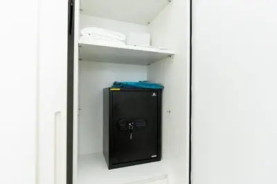 a locker room with a black door with a lock at CitiHome - Modern Stay - Dubai Hills 2BR in Dubai