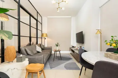 a living room with a couch and a table at CitiHome - Modern Stay - Dubai Hills 2BR in Dubai