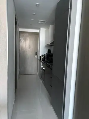 a kitchen with a stove and a door to a room at Luxury Canal View Studio with Pool Damac Maison Prive in Dubai