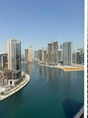 a view of a city with a river and buildings at Luxury Canal View Studio with Pool Damac Maison Prive in Dubai