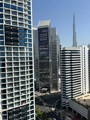 a group of tall buildings in a city at Luxury Canal View Studio with Pool Damac Maison Prive in Dubai