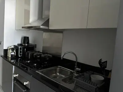 a kitchen with a sink and a counter top at Luxury Canal View Studio with Pool Damac Maison Prive in Dubai