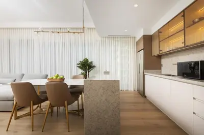 a kitchen and dining room with a table and chairs at Elegant 2BR Apartment with Sea View in Dubai