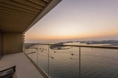 a view of the water from the balcony of a building at Elegant 2BR Apartment with Sea View in Dubai