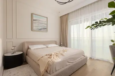 a white bedroom with a bed and a window at Elegant 2BR Apartment with Sea View in Dubai