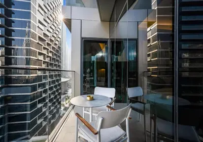 a balcony with a table and chairs on a building at Ultra-Luxury Burj & Fountain Suite at Address Opera in Dubai