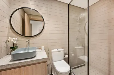a bathroom with a toilet and a sink and a mirror at Spacious & Cozy 2BD Apartment Peninsula One, Dubai in Dubai