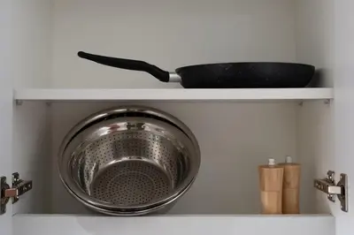 a pot on top of a shelf in a kitchen at Luxury Silicon Oasis Studio Near Mall & Airport in Dubai