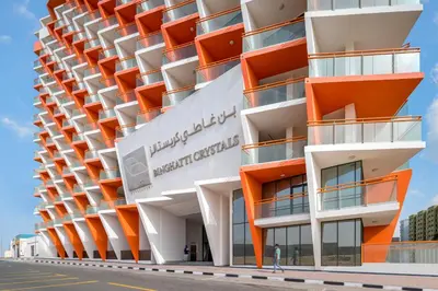 a facade of a building with orange balconies at Luxury Silicon Oasis Studio Near Mall & Airport in Dubai