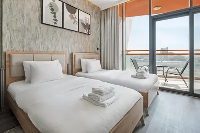 a hotel room with two beds with towels on them at Luxury Silicon Oasis Studio Near Mall & Airport in Dubai