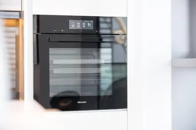 a black microwave oven sitting inside of a kitchen at 3BR Luxury Stay with Maid Room and Views of Ain Dubai & Sea in Dubai