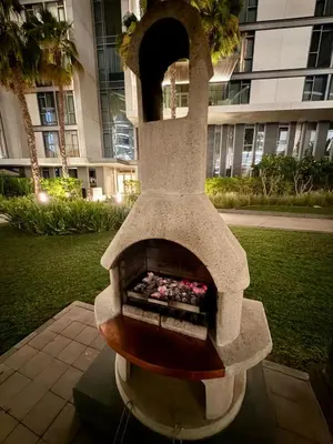 a stone fireplace in front of a building at 3BR Luxury Stay with Maid Room and Views of Ain Dubai & Sea in Dubai