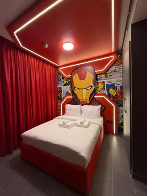 a bedroom with a bed with a superhero headboard at Capsule Super Heroes - Playstation 5 Burj Khalifa View - Near Downtown Dubai in Dubai