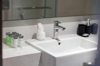 a bathroom with a sink and a mirror at New Luxury Canalfront 2 Bedroom Apartment with Burj Views in Dubai