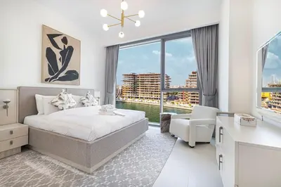 a bedroom with a bed and a large window at New Luxury Canalfront 2 Bedroom Apartment with Burj Views in Dubai