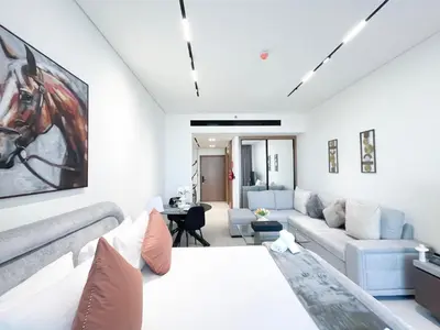a living room with a bed and a couch at Luxury Studio Business Bay Near Dubai Mall in Dubai