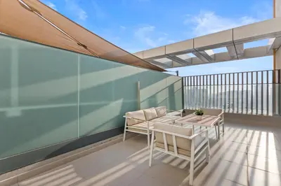 a balcony with a table and chairs on it at Chic Living 1 bedroom near Dubai Hills Mall in Dubai