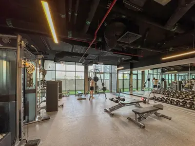 a gym with a bunch of dumbbells and weights at Chic Living 1 bedroom near Dubai Hills Mall in Dubai