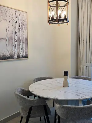 a dining room with a white table and chairs at 1 BR Apartment in Dubai Marina - Paloma Tower - Sea View - 3 Mins away from Tram & Beach in Dubai