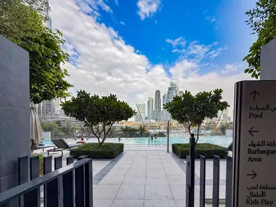 a view of a pool with a city in the background at Luxury Grande 48 with Burj Khalifa & Fountain Views in Dubai