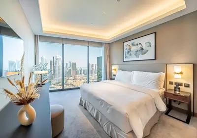 a bedroom with a large bed and a large window at Burj Khalifa & Fountain Sky Suite on The Address Opera in Dubai
