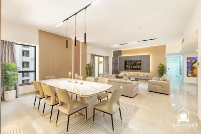 a dining room with a table and chairs at Spacious 4BR Stay Sea JBR Views Sadaf 8 EB in Dubai