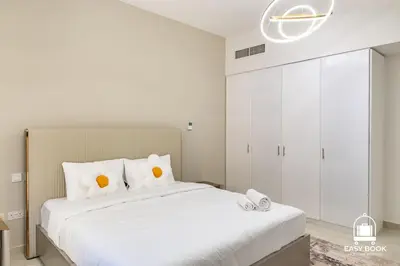 a bedroom with a large white bed with white pillows at Spacious 4BR Stay Sea JBR Views Sadaf 8 EB in Dubai