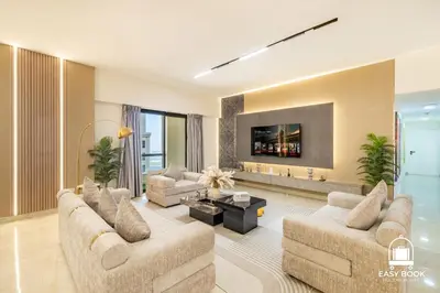 a living room with two couches and a tv at Spacious 4BR Stay Sea JBR Views Sadaf 8 EB in Dubai