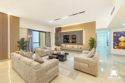 a living room with two couches and a tv at Spacious 4BR Stay Sea JBR Views Sadaf 8 EB in Dubai