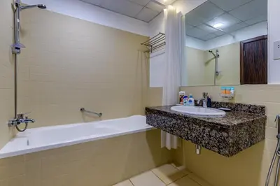 a bathroom with a tub and a sink and a bath tub at Modern 2 BDR Apartment with Sea View Shams 1 JBR in Dubai