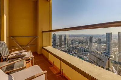a balcony with chairs and a view of a city at Modern 2 BDR Apartment with Sea View Shams 1 JBR in Dubai
