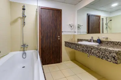 a bathroom with a tub and a sink and a shower at Modern 2 BDR Apartment with Sea View Shams 1 JBR in Dubai
