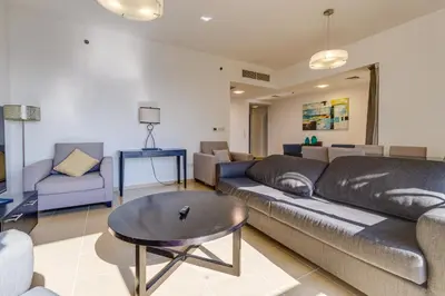 a living room with a couch and a table at Modern 2 BDR Apartment with Sea View Shams 1 JBR in Dubai