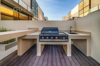 a barbecue grill on a deck in front of a building at Senses at the Fields - Villa with a Private Pool in Dubai