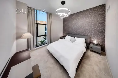 a bedroom with a large white bed and a window at Senses at the Fields - Villa with a Private Pool in Dubai