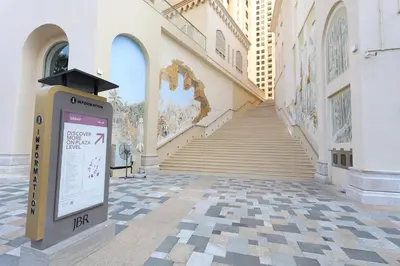 a sign in front of a building with a staircase at Stylish JBR Studio Beach View EB in Dubai